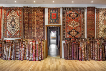 Variety of the gorgeous oriental carpets in traditional carpet store in Middle East - 559605191