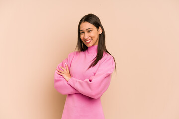 Young colombian woman isolated on beige background happy, smiling and cheerful.