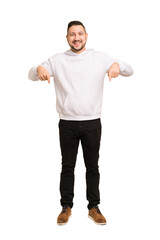 Full body adult latin man cut out isolated points down with fingers, positive feeling.