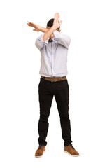 Full body adult latin man cut out isolated keeping two arms crossed, denial concept.