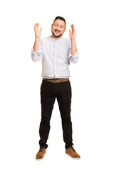 Full body adult latin man cut out isolated joyful laughing a lot. Happiness concept.