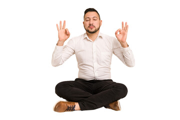 Adult latin man sitting on the floor cut out isolated relaxes after hard working day, she is...