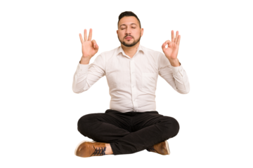 Adult latin man sitting on the floor cut out isolated relaxes after hard working day, she is performing yoga.