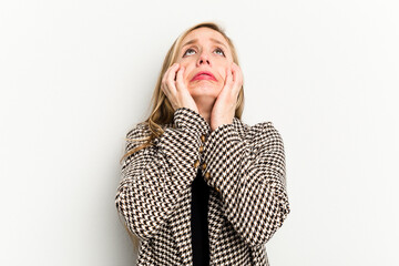 Young caucasian woman isolated on white background crying, unhappy with something, agony and confusion concept.