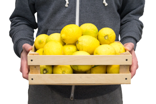 Man with wooden box in hand with lemons with white background still life

