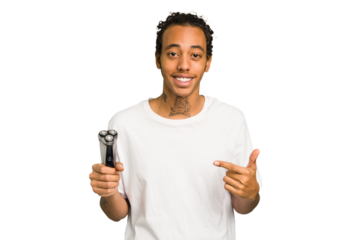 Young African American man holding a razor isolated person pointing by hand to a shirt copy space, proud and confident