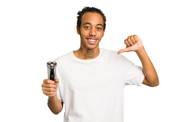 Young African American man holding a razor isolated feels proud and self confident, example to...