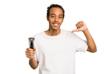 Young African American man holding a razor isolated feels proud and self confident, example to follow.