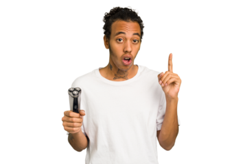 Young African American man holding a razor isolated having an idea, inspiration concept.