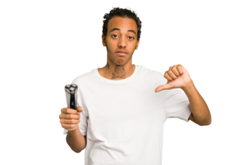 Young African American man holding a razor isolated showing a dislike gesture, thumbs down. Disagreement concept.