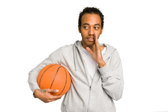 Young african american man playing basketball isolated is saying a secret hot braking news and looking aside