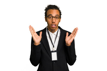 Young African American business man with badge isolated surprised and shocked.