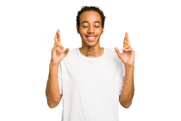 Young African American man isolated crossing fingers for having luck
