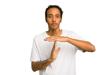 Young African American man isolated showing a timeout gesture.