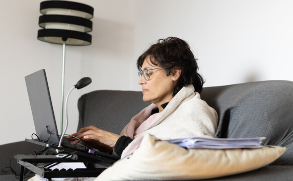 Mature Middle Eastern Woman In Pajamas Working On Laptop At Home Stressed.