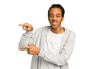 Young African American man isolated excited pointing with forefingers away.