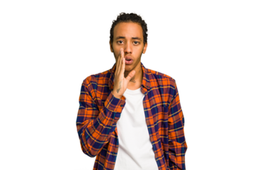Young African American man isolated is saying a secret hot braking news and looking aside