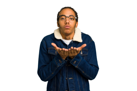 Young African American man isolated folding lips and holding palms to send air kiss.