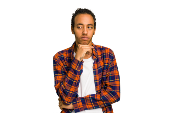 Young African American man isolated looking sideways with doubtful and skeptical expression.