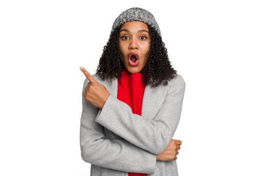 Young african american woman wearing winter jacket isolated pointing to the side