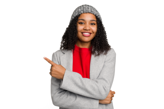 Young african american woman wearing winter jacket isolated smiling and pointing aside, showing something at blank space.