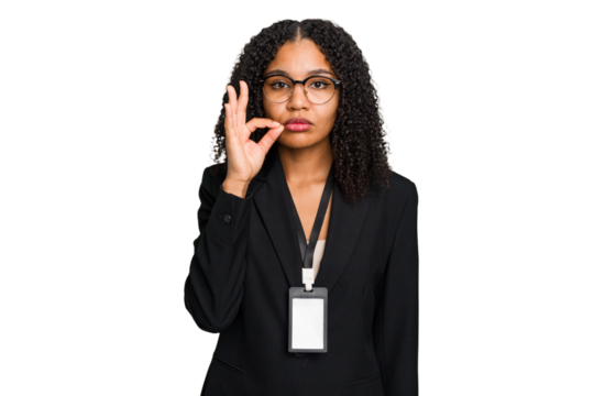 Young african american business woman with ID card isolated with fingers on lips keeping a secret.
