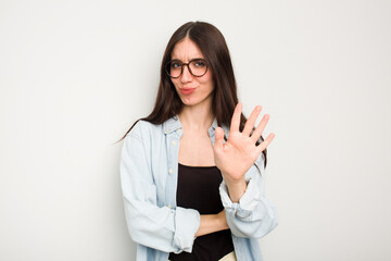 Young caucasian woman isolated on white background rejecting someone showing a gesture of disgust.