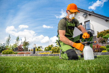 Professional Gardener with One Handed Pump Pesticide Sprayer - obrazy, fototapety, plakaty