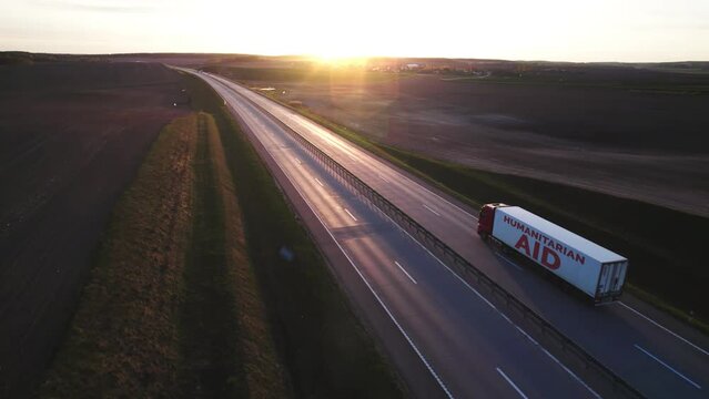Large truck with a trailer loaded with humanitarian aid for people affected by war, natural disaster, famine, cataclysm. Transportation of medicines, food and basic necessities for Ukrainian refugees