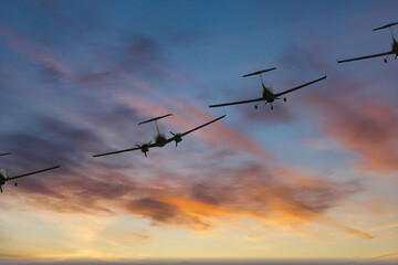 Fototapeta na wymiar A group of four turboprop aircraft flies in the sunset sky.