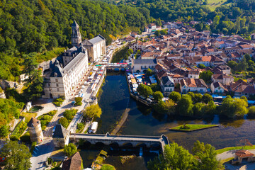 Picturesque aerial view of summer cityscape of Brantome en Perigord looking out over medieval abbey on banks of Dronne River, France..