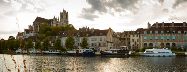 Image of view with river of famous old town Auxerre at cloudy day in France