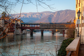 The Ponte Vecchio (Old bridge) is the covered wooden in Bassano del Grappa that spans the river Brenta designed by the architect Andrea Palladio in 1569 - obrazy, fototapety, plakaty