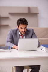 Young male employee working from home during pandemic