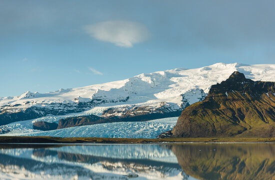 Scenic View Of Lake By Mountains Against Sky During Winter