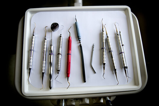 Dental instrumants laid out on a tray.