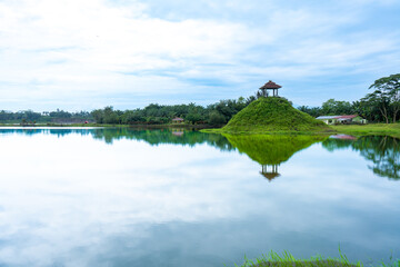 A landscape scenery with a lot of trees, a lake, and a lone pavilion, colorful scenery