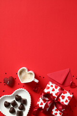 Valentines Day vertical background with gift box, candy, heart shaped cup of coffee, candles, envelope. Love, romance concept.