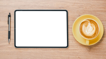 Office wooden desk workplace with blank screen tablet, pen and cup of coffee, Top view flat lay with copy space.
