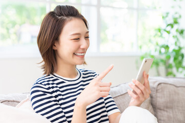 スマホを見る女性　笑顔