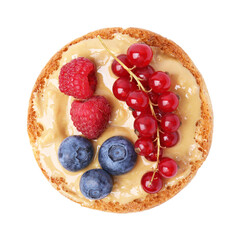 Tasty organic rusk with peanut butter and sweet berries isolated on white, top view