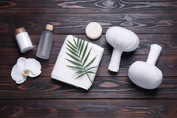 Fototapeta na wymiar Flat lay composition of herbal bags and spa products on wooden table