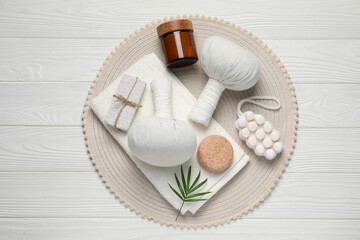 Fototapeta na wymiar Composition of herbal bags and spa products on white wooden table, top view