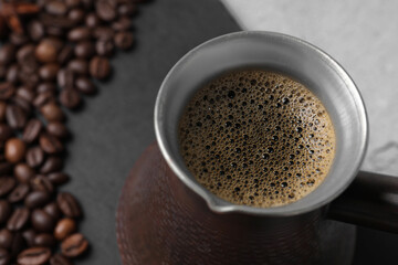 Turkish coffee in cezve on table, closeup