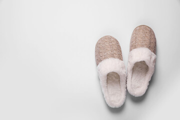 Pair of beautiful soft slippers on white background, top view. Space for text
