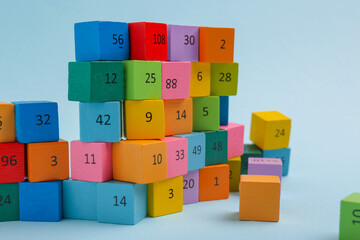 Wooden cubes with different numbers on light background