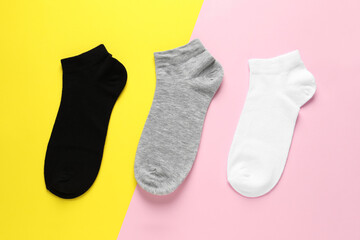 Different socks on colorful background, flat lay