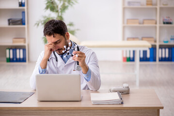 Young male doctor studying molecular model