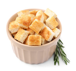Delicious crispy croutons in bowl and rosemary on white background