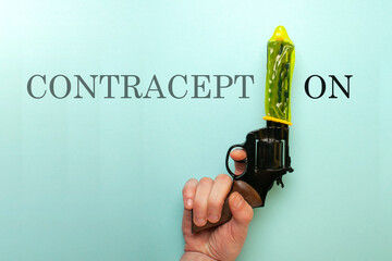 concept of a strong condom, a yellow contraceptive dressed on the muzzle of a gun, the concept of...